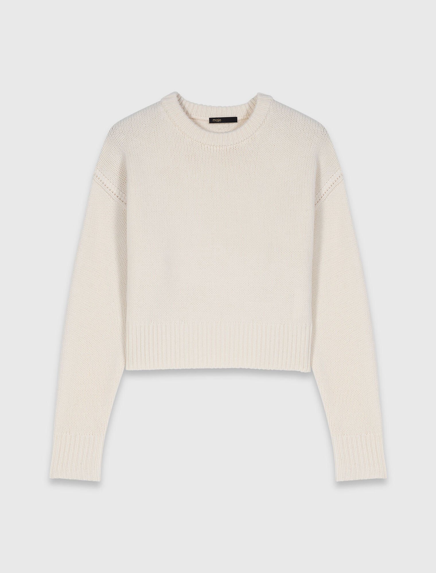 Sweater with floral brooch