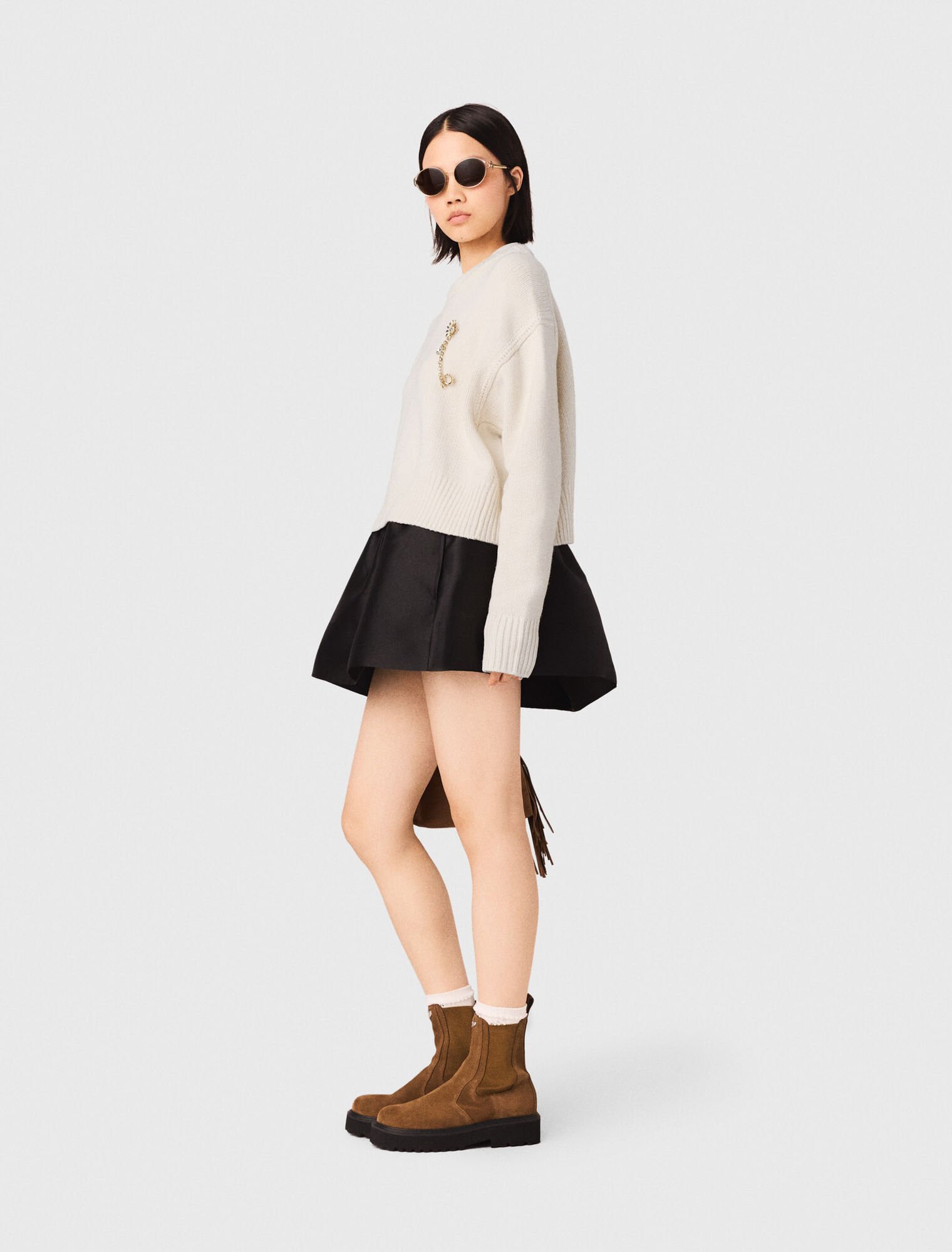 Sweater with floral brooch