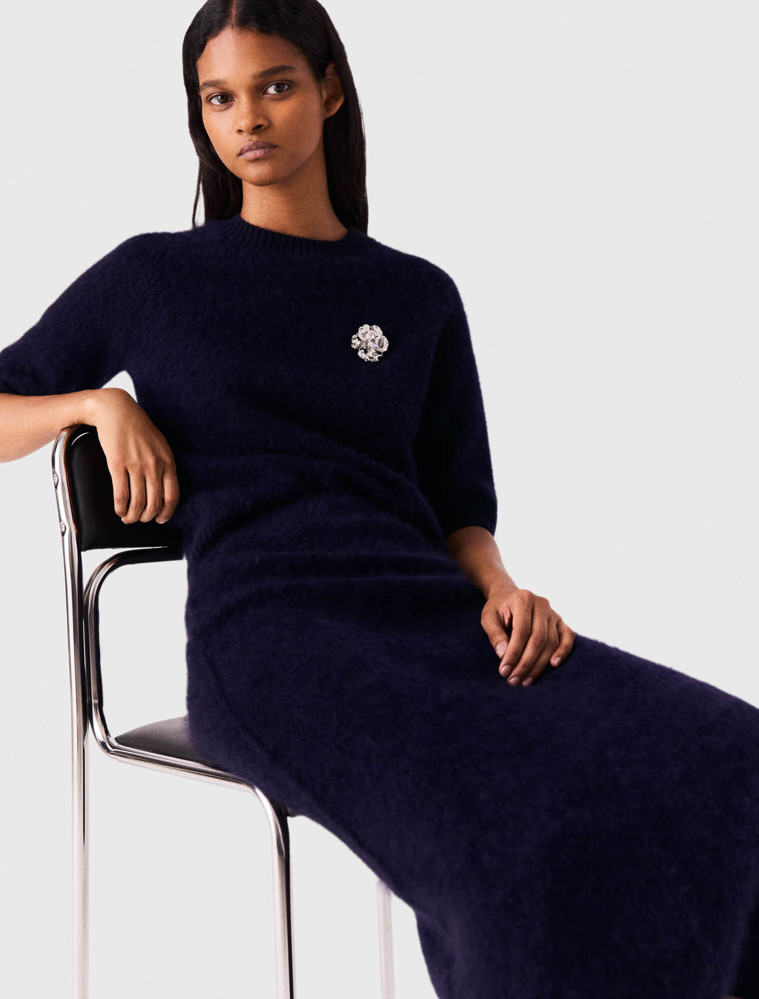 Jumper with floral brooch