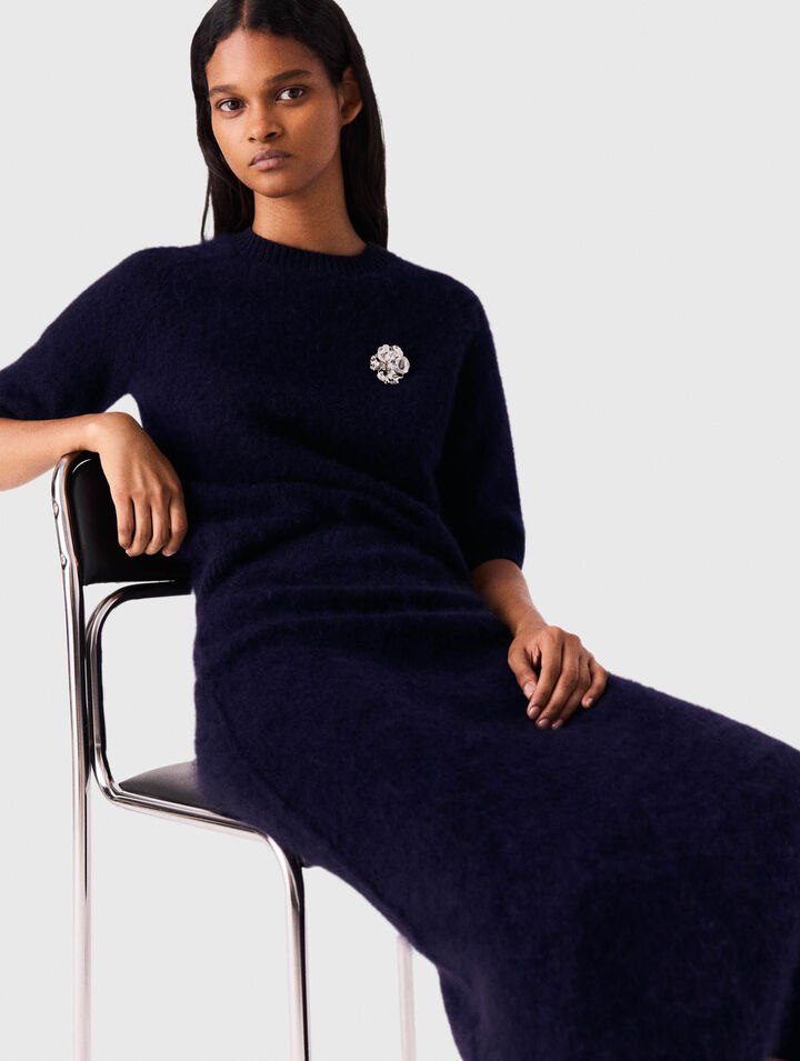 Jumper with floral brooch