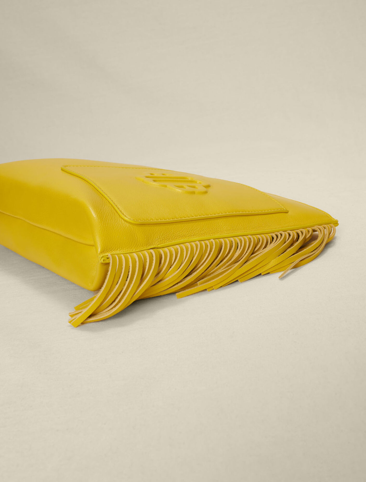 Fringed leather clutch bag