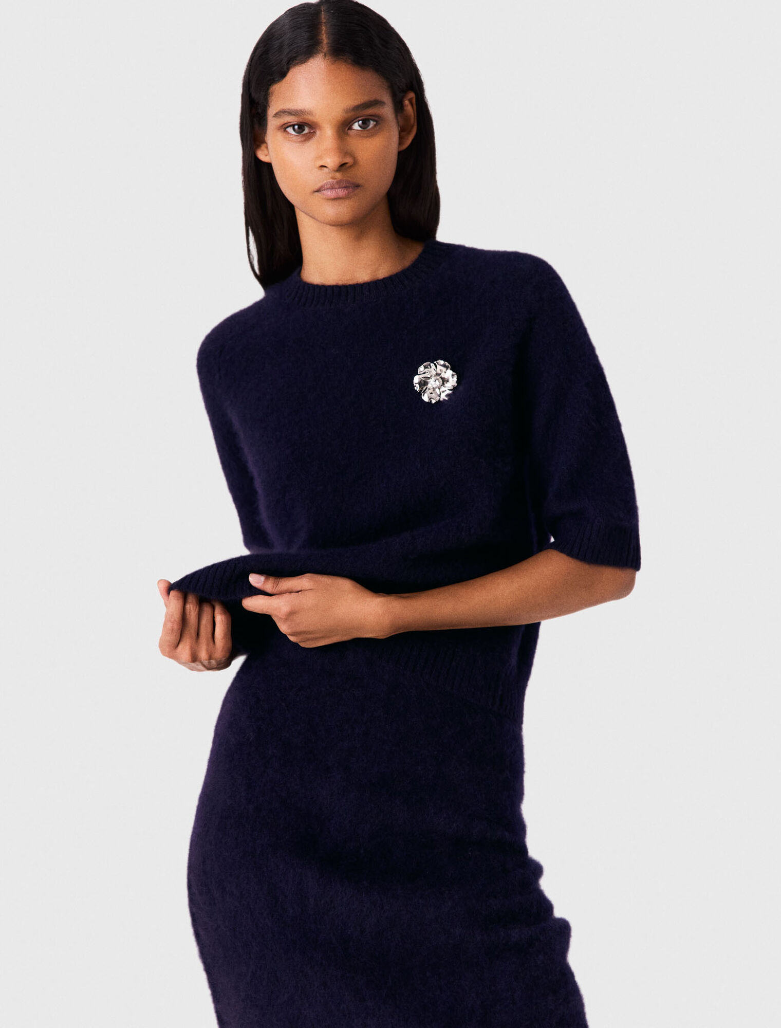 Jumper with floral brooch